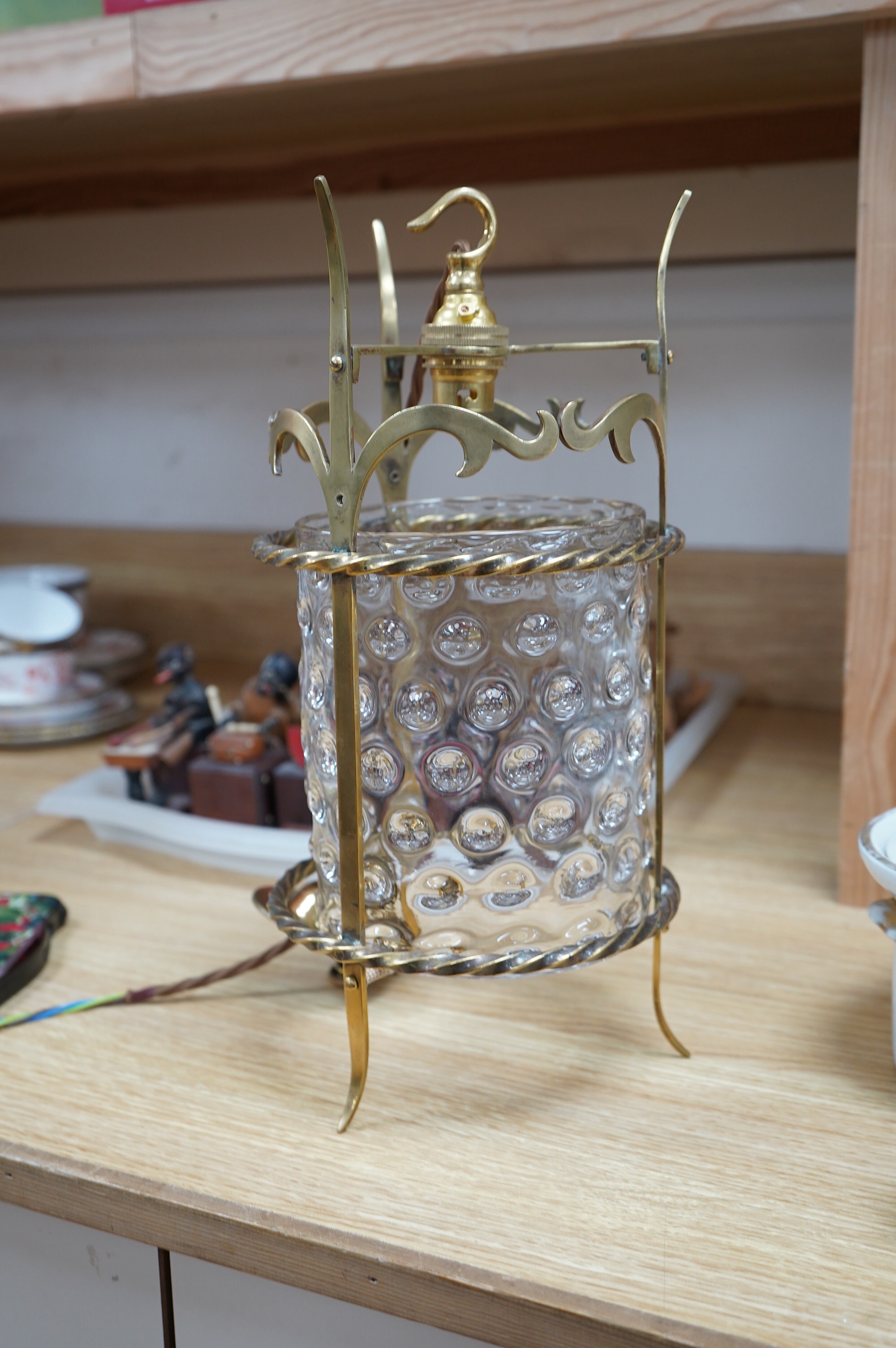 An English Art Nouveau brass lantern with wavy bubbly glass cylinder, c.1910-1920's, including chain and ceiling rose, wired, lantern 34cm high, diameter 13.5cm, glass 16.5cm high. Condition - glass shade a little loose